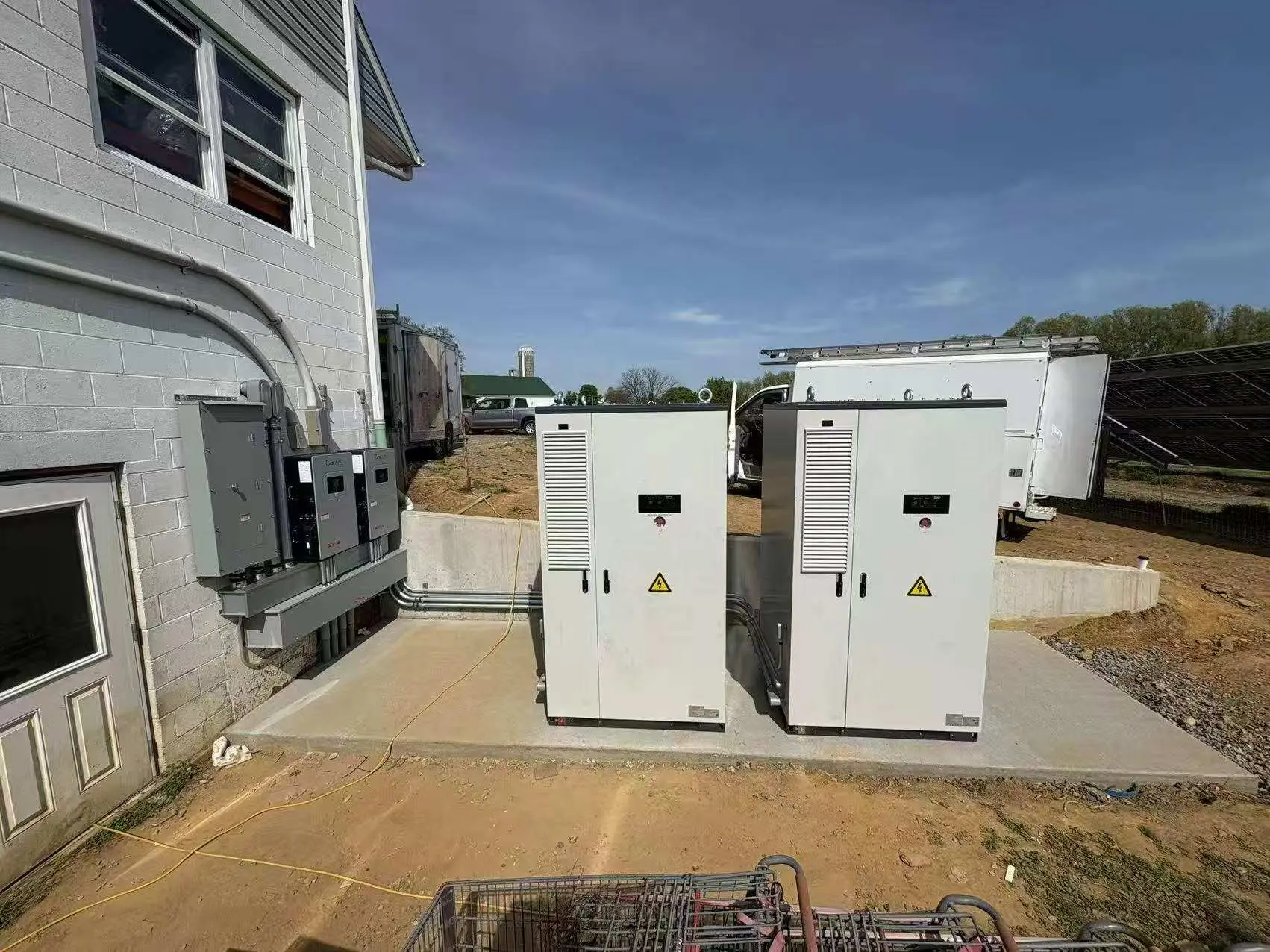 Four commercial battery energy storage cabinets connected to building electrical distribution