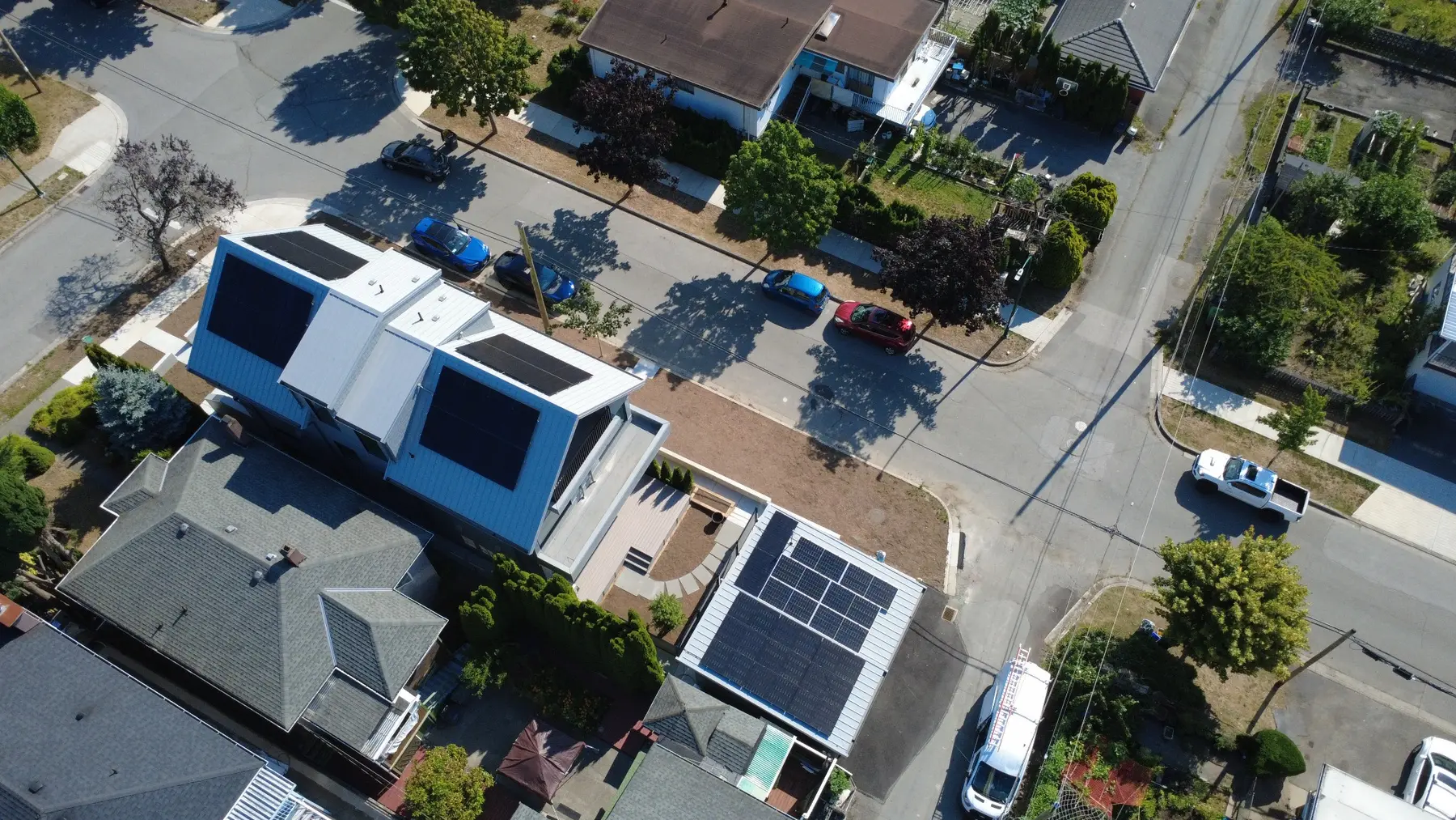 Aerial view of the E11 Vancouver residence and accessory building with rooftop solar arrays