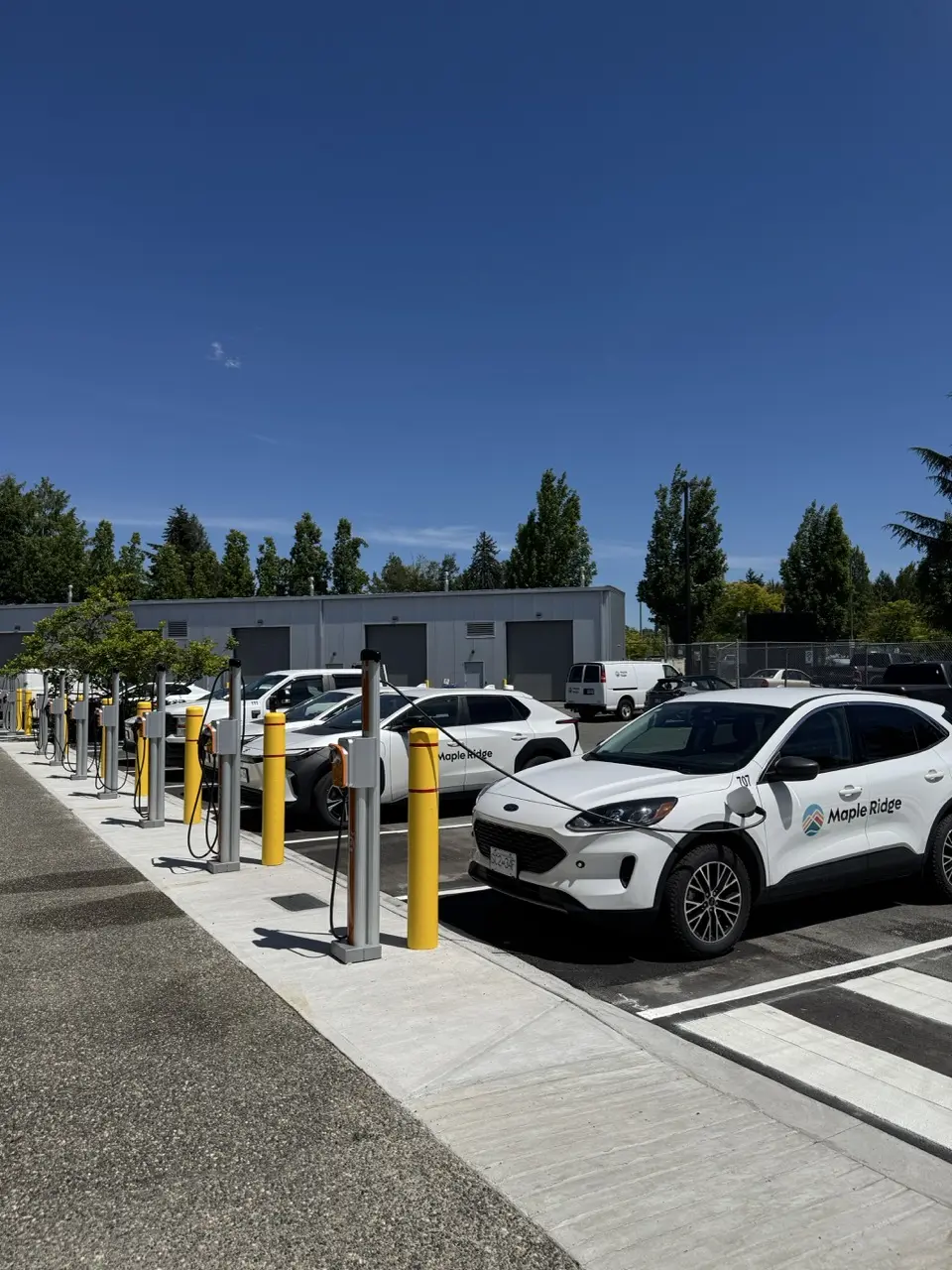 Completed Maple Ridge municipal fleet charging deployment with vehicles and pedestals