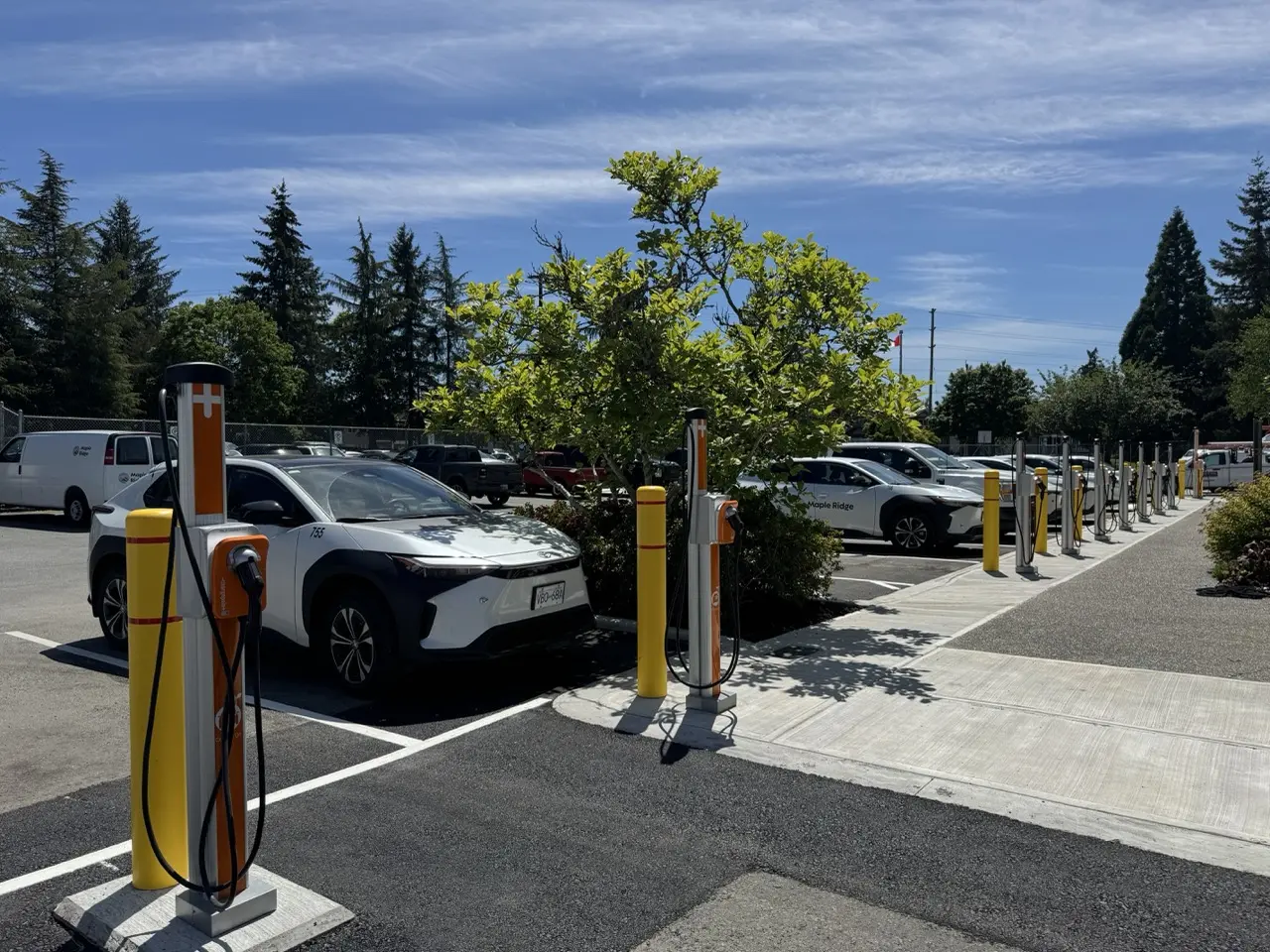 Maple Ridge fleet vehicles charging beside the completed 18-port municipal installation