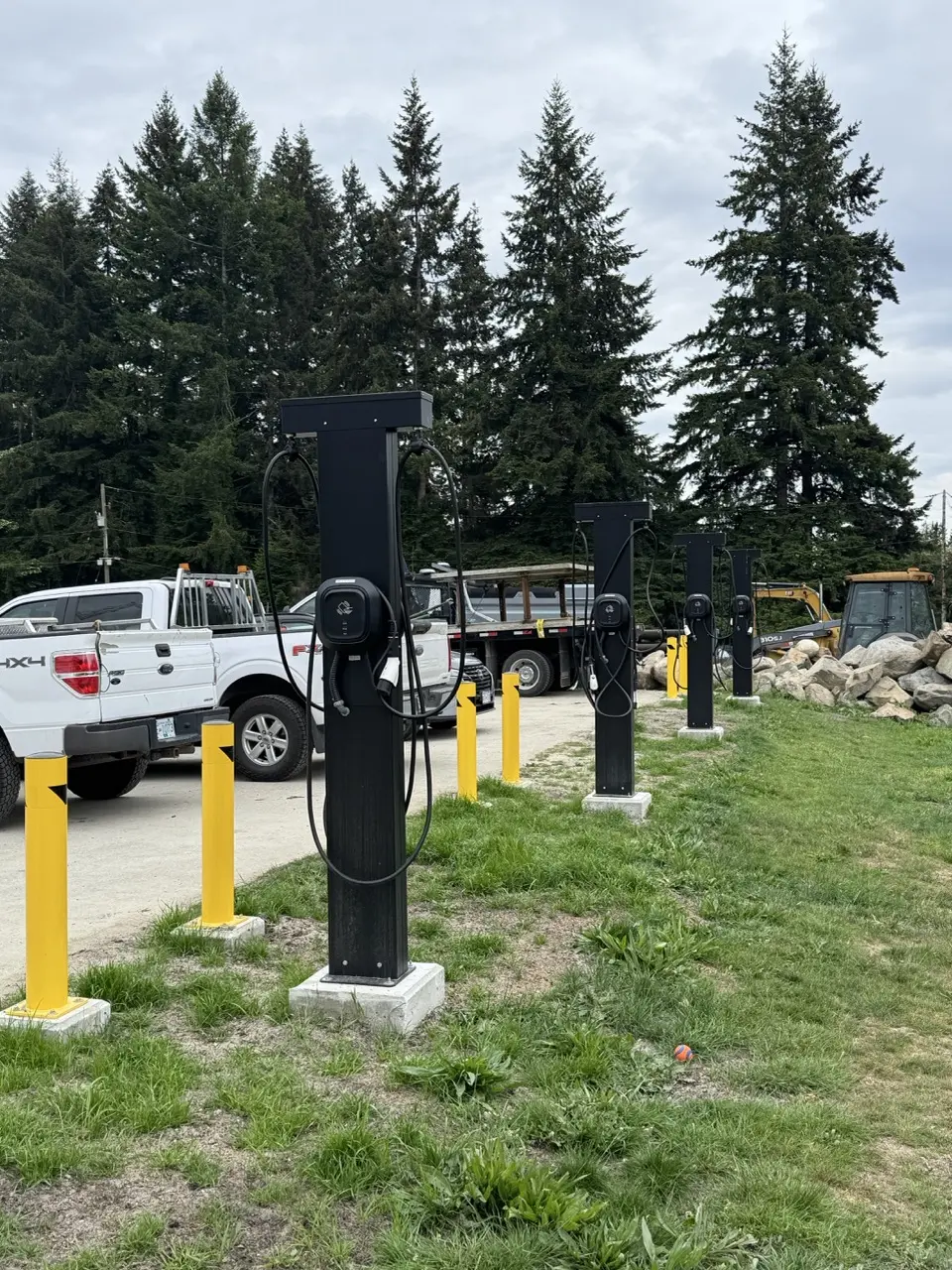 Row of dual-cord Level 2 charging pedestals on the Sunshine Coast